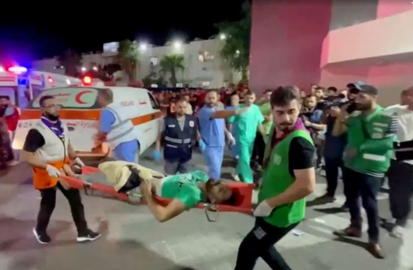  An injured person is taken into a hospital after an explosion at a hospital, according to Hamas Health Ministry in Gaza City, Gaza Strip, in this screen grab obtained from video, October 17, 2023. (photo credit: REUTERS/Reuters TV)