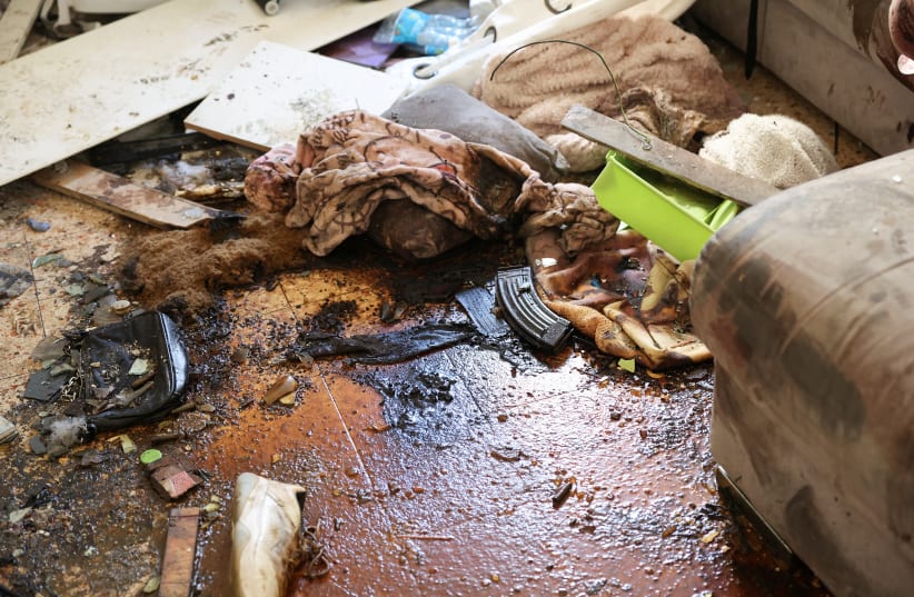 A view of a weapon magazine on the floor of a house, following a deadly infiltration by Hamas gunmen from the Gaza Strip, in Kibbutz Kfar Aza in southern Israel, October 18, 2023.  (photo credit: REUTERS/VIOLETA SANTOS MOURA)