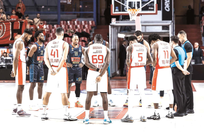  HAPOEL TEL AVIV and Reyer Venice players stand for a moment of silence for war victims prior to their EuroCup game in Italy. (photo credit: HAPOEL KATAMON JERUSALEM)