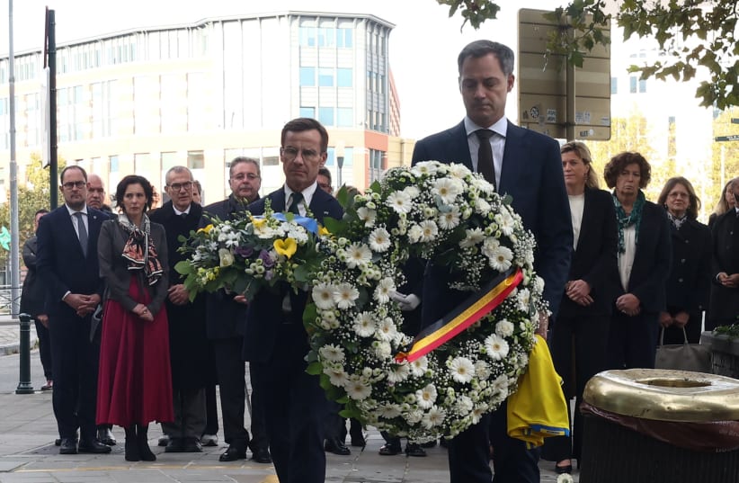 Swedish Prime Minister Ulf Kristersson and Belgian Prime Minister Alexander De Croo pay tribute to the victims two days after a gunman shot dead two Swedes, at the place of the shooting in Brussels, Belgium October 18, 2023. (photo credit: YVES HERMAN/REUTERS)