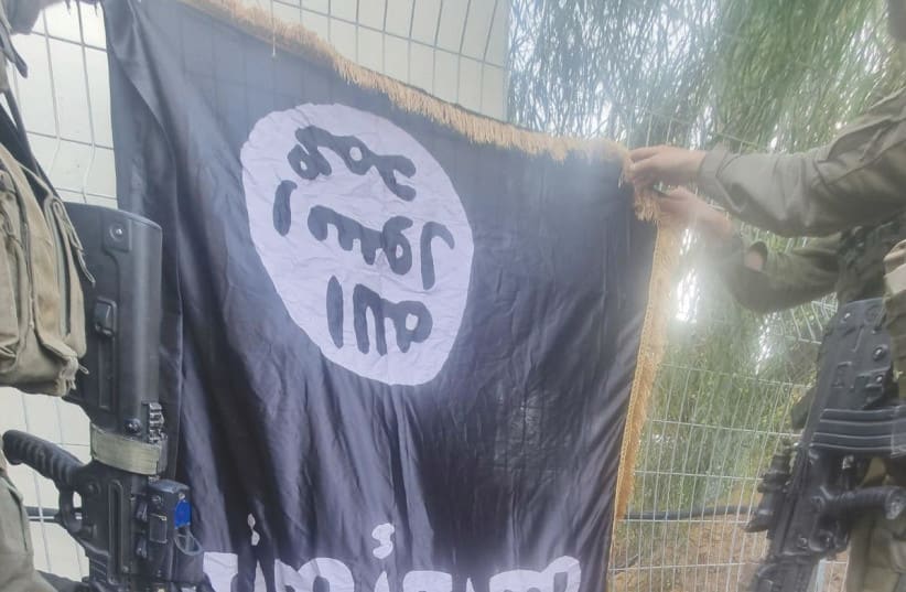  AN ISIS FLAG is left behind at Kibbutz Sufa after this month’s massacre was carried out by infiltrating Hamas terrorists. (photo credit: IDF SPOKESPERSON'S UNIT)