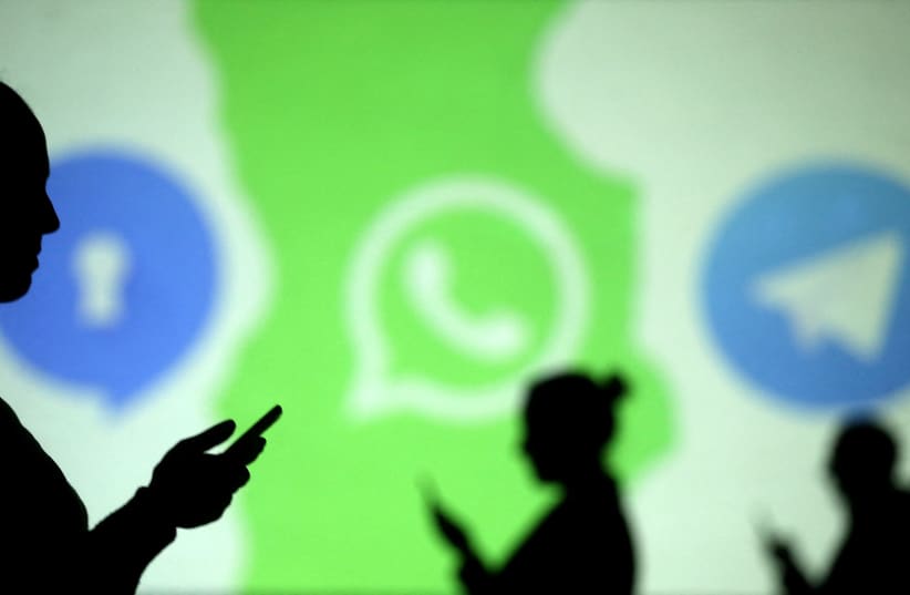  Silhouettes of mobile users are seen next to logos of social media apps Signal, Whatsapp and Telegram projected on a screen in this picture illustration taken March 28, 2018. (photo credit: REUTERS/DADO RUVIC/ILLUSTRATION/FILE PHOTO)