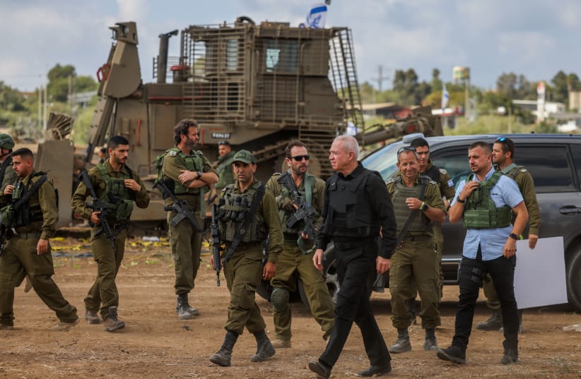  Defense Minister Yoav Gallant speaks with Israeli soldiers at a staging area not far from the Israeli-Gaza border, October 19, 2023 (photo credit: Chaim Goldberg/Flash90)