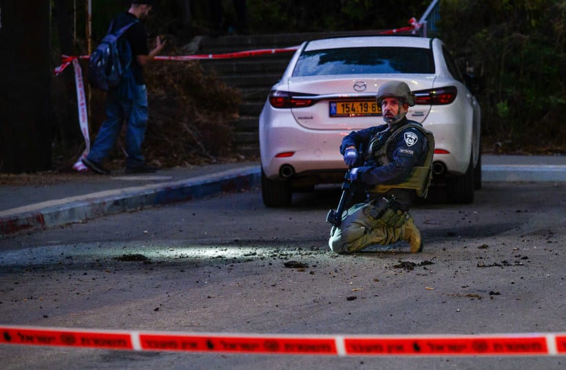 Israeli security and rescue forces at the site where a rocket fired from Lebanon hit in the northern town of Kiryat Shmona, October 19, 2023 (photo credit: AYAL MARGOLIN/FLASH90)