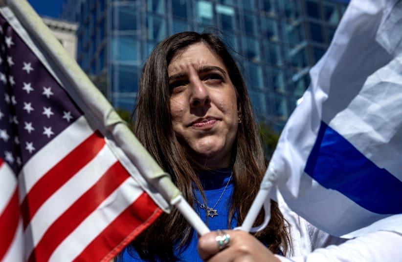  A woman looks on as she attends a "Stand with Israel" rally at Freedom Plaza in Washington, U.S., October 13, 2023.  (photo credit: REUTERS/EVELYN HOCKSTEIN)