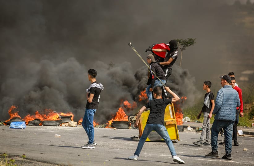  PALESTINIANS CLASH with Israeli soldiers in Ramallah, during a protest to mark the 70th anniversary of  the ‘Nakba,’ in May 2018. (photo credit: FLASH90)