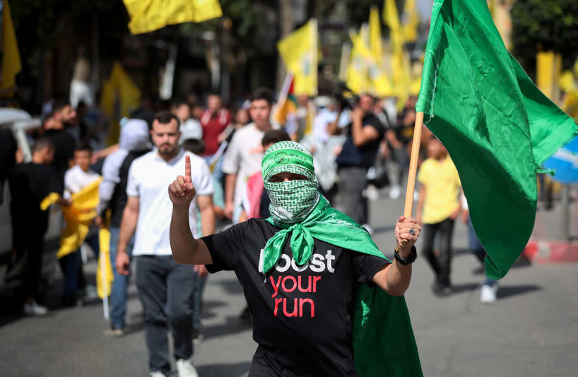  Palestinians take part in a protest in support of the people of Gaza, as the conflict between Israel and Hamas continues, in Hebron in the West Bank, October 20, 2023. (photo credit: WISAM HASHLAMOUN/FLASH90)