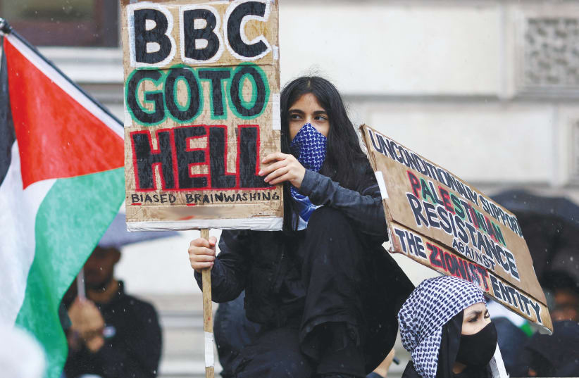  A PRO-PALESTINIAN protester blasts the BBC after it admitted it was wrong to blame Israel for the Al-Ahli Hospital explosion, while another sign calls for ‘Resistance against the Zionist entity,’ in London. (photo credit: REUTERS/HANNAH MCKAY)