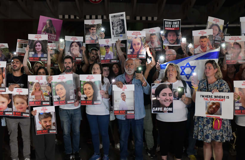  Families of Israelis held hostage by Hamas terrorists in Gaza hold up photographs of their abducted family members, at  "Hostage Square", outside the Art Museum of Tel Aviv, October 21, 2023 (photo credit: TOMER NEUBERG/FLASH90)