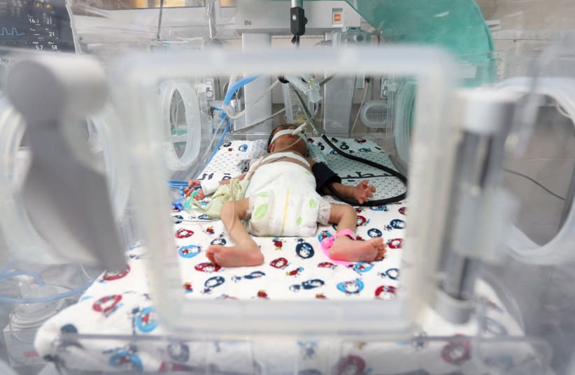 A premature Palestinian baby lies in an incubator at the maternity ward of Shifa Hospital, which according to health officials is about to shut down as it runs out of fuel and power, as the conflict between Israel and the terrorist group Hamas continues, in Gaza City October 22, 2023. (photo credit: REUTERS/MOHAMMED AL-MASRI)