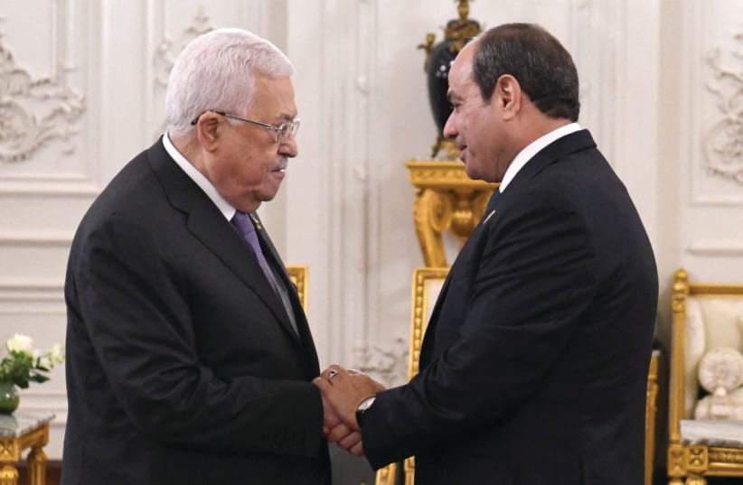  EGYPTIAN PRESIDENT Abdel Fattah al-Sisi greets PA head Mahmoud Abbas at an international summit for Middle East peace in the New Administrative Capital, east of Cairo (photo credit: THE EGYPTIAN PRESIDENCY/REUTERS)