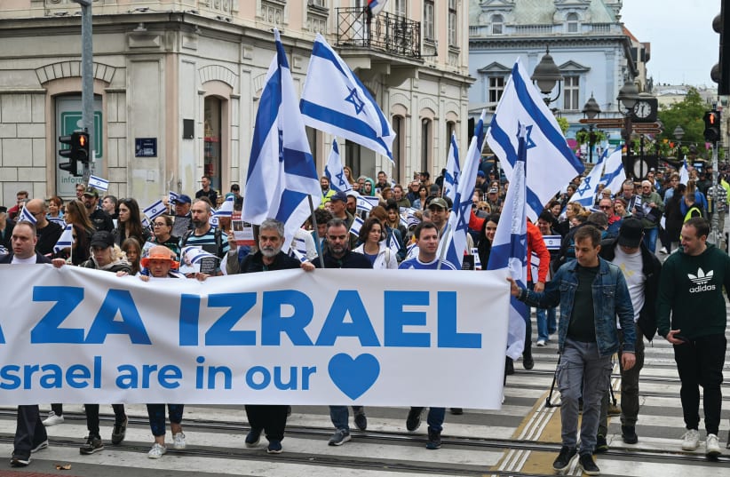  A WALK in support of Israel takes place through the center of Belgrade. The banner reads: ‘The people of Israel are in our hearts.’  (photo credit: Haver Serbia)