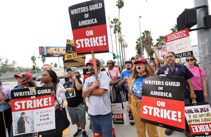  SAG-AFTRA actors and Writers Guild of America (WGA) writers walk the picket line during their ongoing strike outside Netflix offices in Los Angeles, California, US, September 22, 2023. (photo credit: REUTERS/MARIO ANZUONI/FILE PHOTO)