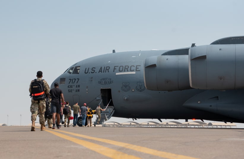 Members of the 4th Expeditionary Fighter Squadron, board a C-17 Globemaster III to forward deploy to an undisclosed location in Southwest Asia in support of exercise Agile Lightning from Al Dhafra Air Base, Abu Dhabi, United Arab Emirates. (photo credit: Chris Thornbury/US Air Force/Handout via REUTERS)