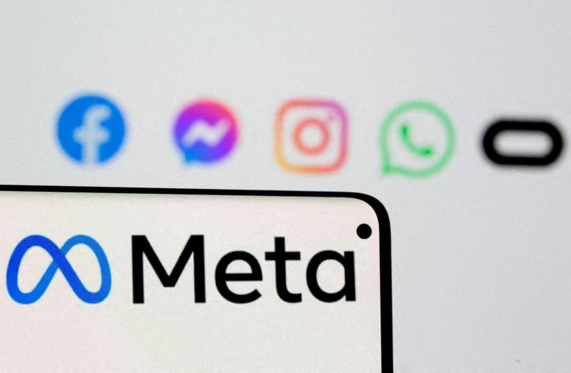  Facebook's new rebrand logo Meta is seen on smartphone in front of displayed logo of Facebook, Messenger, Instagram, Whatsapp and Oculus in this illustration picture taken October 28, 2021 (photo credit: REUTERS/ DADO RUVIC)