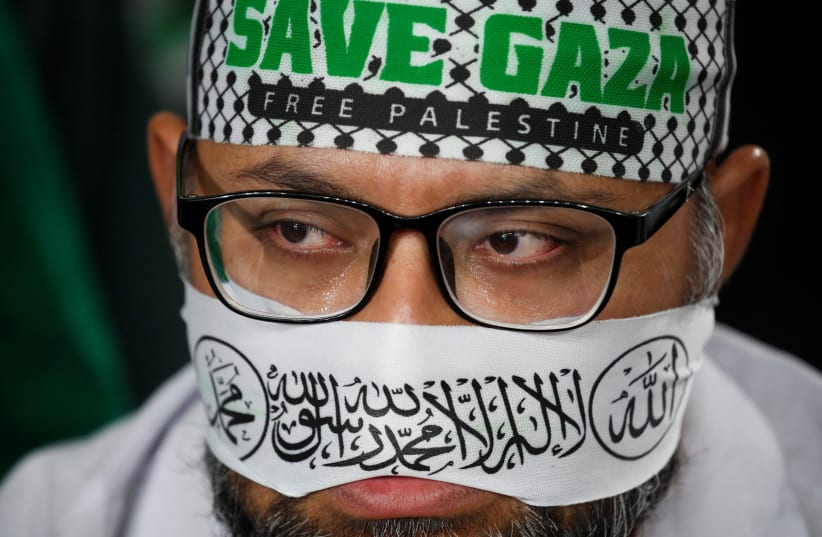  A man wears a headband during a solidarity gathering to show support for Palestinians, amid escalating conflict between Israel and Hamas, in Kuala Lumpur, Malaysia, October 24, 2023 (photo credit: REUTERS/Hasnoor Hussain)