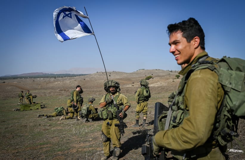 Israeli reserve soldiers seen during a military training before heading to the Israeli-Gaza border in the Golan Heights, northern Israel, on October 25, 2023 (photo credit: MICHAEL GILADI/FLASH90)
