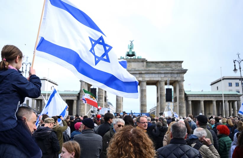  People attend the rally "Against terror and antisemitism! Solidarity with Israel" at Brandenburg Gate, amid the ongoing conflict between Israel and the Palestinian Islamist group Hamas, in Berlin, Germany October 22, 2023.  (photo credit: ANNEGRET HILSE / REUTERS)