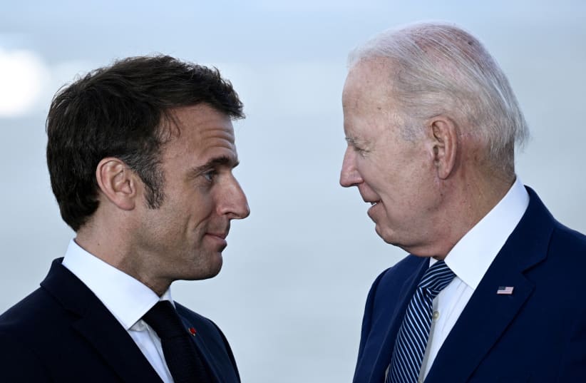 France's President Emmanuel Macron speaks with US President Joe Biden after a family photo of leaders of the G7 and invited countries during the G7 Leaders' Summit in Hiroshima on May 20, 2023. (photo credit: BRENDAN SMIALOWSKI/POOL VIA REUTERS)
