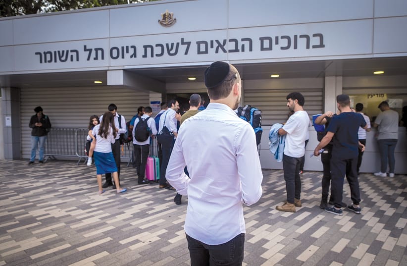  HAREDI MEN join up with the IDF at the Tel Hashomer recruiting offices, Oct. 23. (photo credit: AVSHALOM SASSONI/FLASH90)