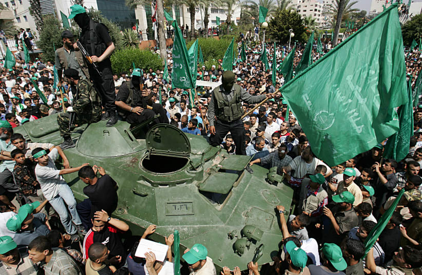  HAMAS OPERATIVES ride an armored vehicle (seized from Fatah) during a rally celebrating their June 14, 2007, takeover of the Gaza Strip.  (photo credit: Abid Katib/Getty Images)