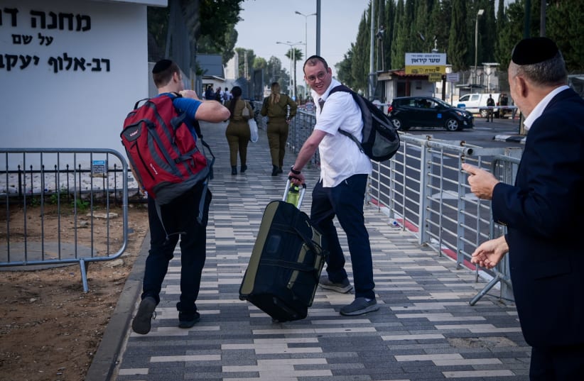 Ultra orthodox Jewish men who decided to join in the IDF following the ongoing war between Israel and Hamas arrive at the IDF recruiting offices in Tel Hashomer, near Tel Aviv, October 23, 2023.  (photo credit: AVSHALOM SASSONI/FLASH90)