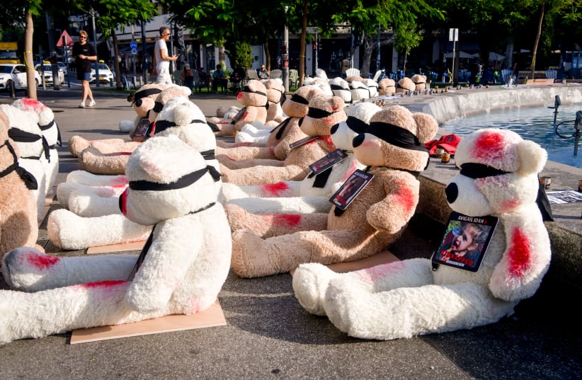  LARGE TEDDY bears with splotches of red paint and the photographs of the children held hostage by Hamas terrorists in Gaza are displayed at Tel Aviv’s Dizengoff Square on October 25 (photo credit: AVSHALOM SASSONI/FLASH90)