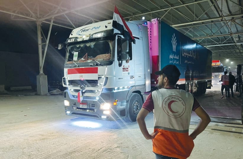 HUMANITARIAN AID crosses from Egypt to Gaza, at the Rafah crossing, this week. Hamas belligerence has led to an Egyptian and Israeli attempt to control what comes into Gaza. Does that make it an open-air prison?  (photo credit: Palestine Red Crescent Society/Reuters)