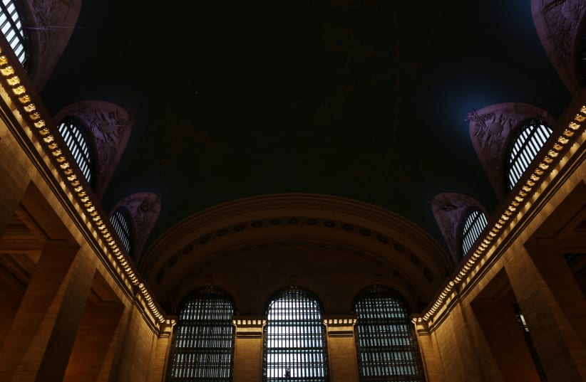  A man walks in silhouette at Grand Central Station in New York City, US, September 18, 2023. (photo credit: REUTERS/SHANNON STAPLETON)