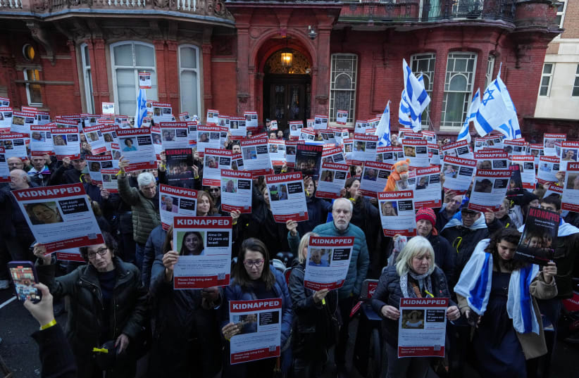  Demonstrators hold banners as they form a human chain outside the Qatar embassy in a protest calling for the release of the Israeli hostages being held by Hamas in London, Britain, October 29, 2023. (photo credit: REUTERS/Maja Smiejkowska)