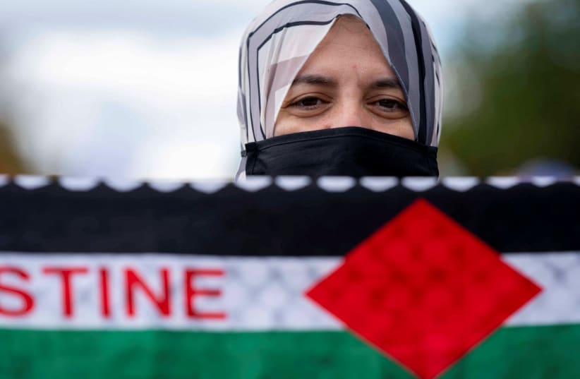  A woman looks on during a rally held by American Muslims for Palestine calling for a cease fire in Gaza in Washington, U.S., October 21, 2023 (photo credit: REUTERS/BONNIE CASH)