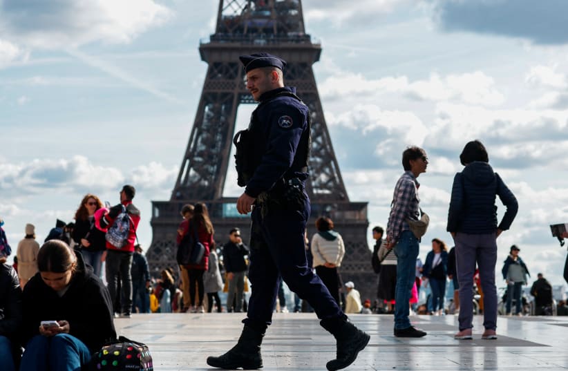  French police patrol at the Trocadero Square near the Eiffel Tower in Paris as French government puts nation on its highest state of alert after a deadly knife attack in northern France, October 15, 2023. (photo credit: REUTERS/GONZALO FUENTES)