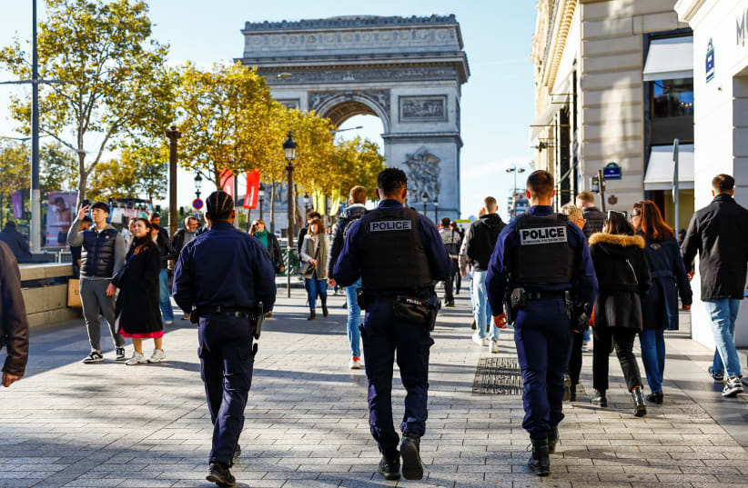  French police patrol on the Champs Elysees avenue near the Arc de Triomphe in Paris, as the French government puts the nation on its highest state of alert after a deadly knife attack in northern France, October 16, 2023. (photo credit: REUTERS/GONZALO FUENTES)