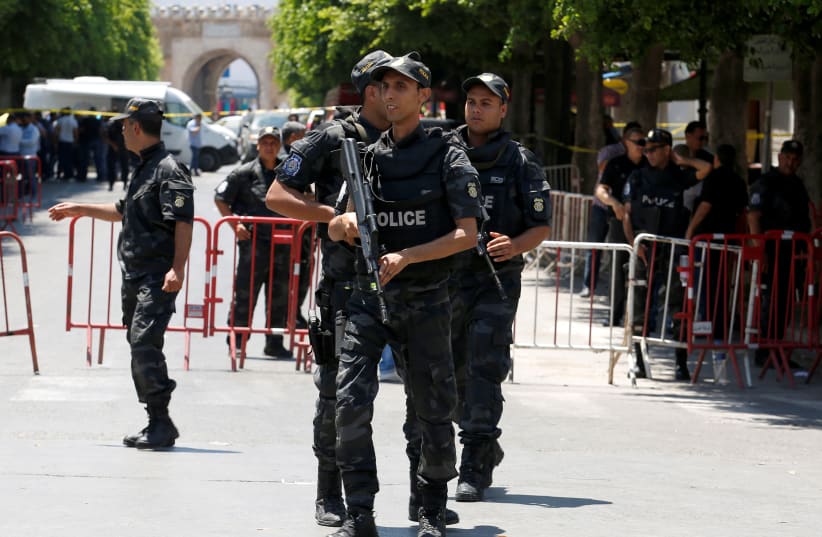  Police officers stand guard near the site of a suicide bombing attack in downtown Tunis, Tunisia June 27, 2019. (photo credit: REUTERS/ZOUBEIR SOUISSI)