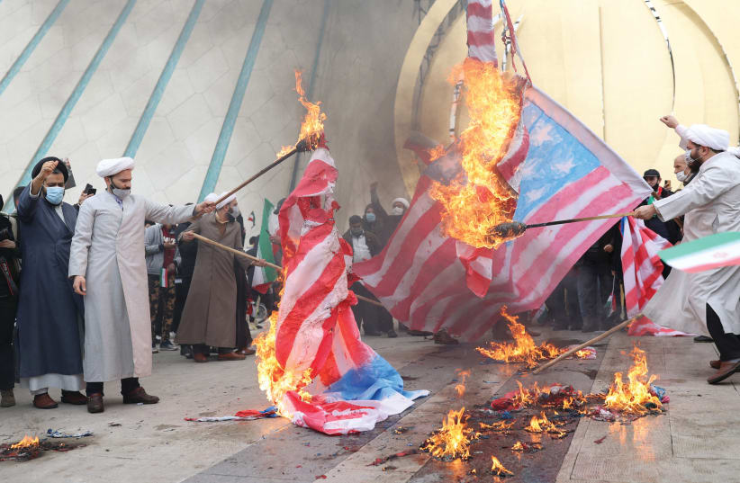  IRANIAN CLERICS set fire to American flags on February 11, 2022, the 43rd anniversary of the Islamic Revolution, in Tehran.  (photo credit: Majid Asgaripour/West Asia News Agency/Reuters)