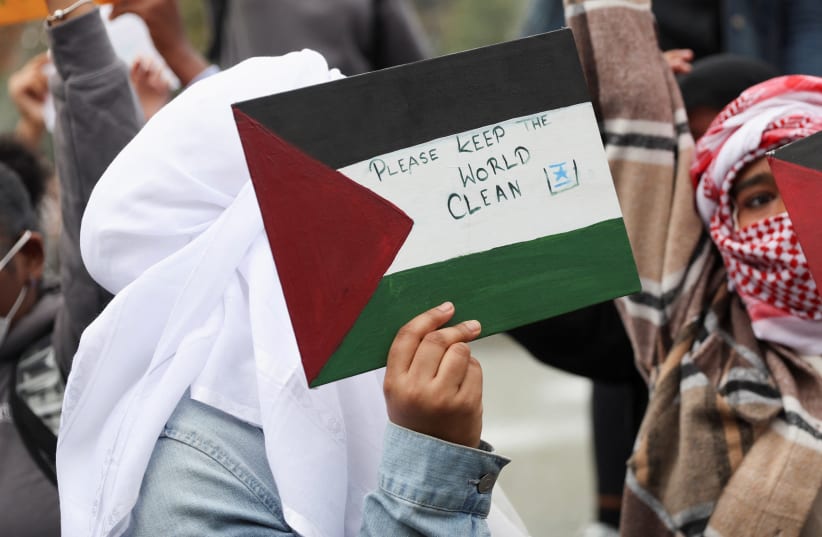 A person holds a sign during a demonstration to express solidarity with Palestinians in Gaza, amid the ongoing conflict between Israel and Hamas, as part of a student walkout by students of New York University, in New York City, US, October 25, 2023.  (photo credit: Shannon Stapleton/Reuters)