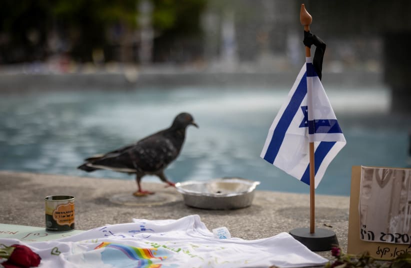  Flags, candles, flowers in memory of the more than 1500 slaughtered when hamas infiltrated Israel on Oct 7, and 239 Israelis taken hostage by Hamas terrorists into Gaza,  on Dizengoff Square. October 29, 2023.  (photo credit: CHAIM GOLDBEG/FLASH90)