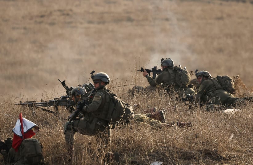 Israeli soldiers take part in a military drill near the border between Israel and Syria at the Golan Heights, November 2, 2023.  (photo credit: REUTERS/VIOLETA SANTOS MOURA)