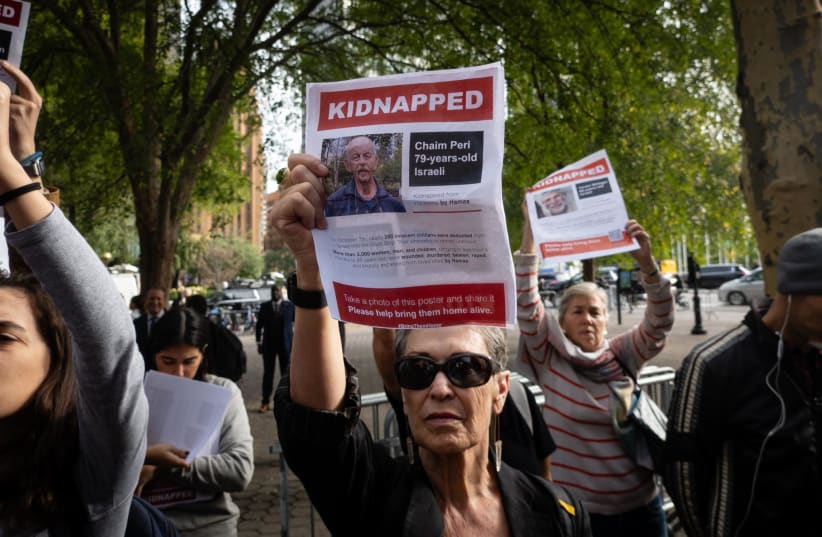  Israel supporters hold images of Hamas hostages at a rally demanding their release, in New York City, October 18, 2023.  (photo credit: LUKE TRESS)
