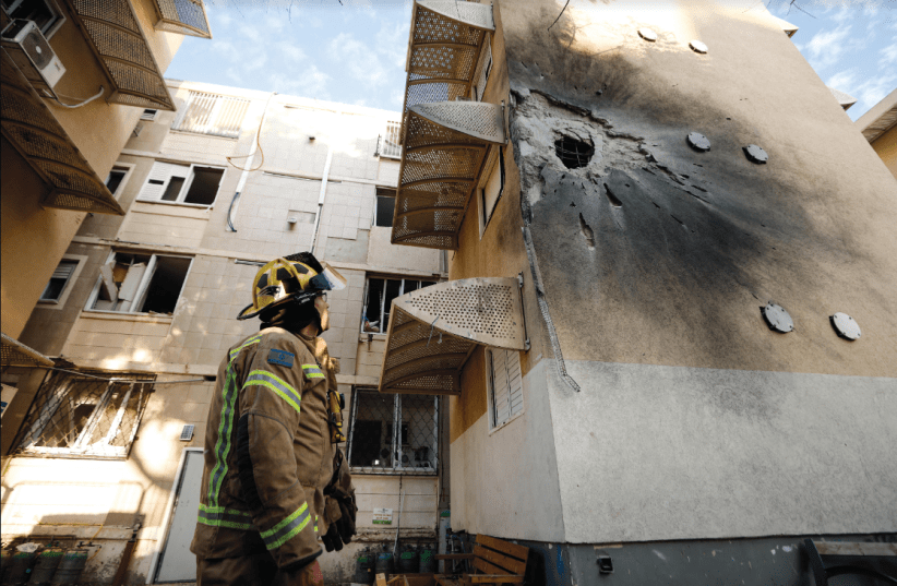 A damaged home is seen after it was hit by a rocket launched from the Gaza Strip into Sderot on October 17 (photo credit: AMIR COHEN/REUTERS)