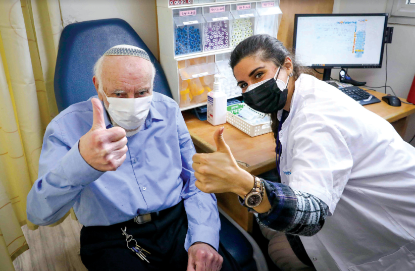  A man receives a COVID-19 vaccination at a health clinic in Jerusalem (photo credit: MARC ISRAEL SELLEM)