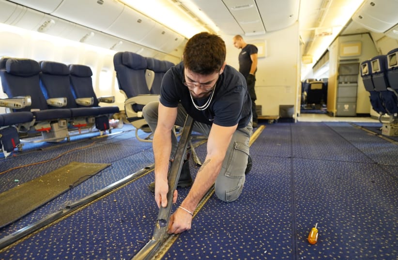  El Al employees remove passenger seats from a Boeing 777, so that the plane can be used to transport cargo to Israel during the ongoing war with Hamas in Gaza. (photo credit: EL AL on X)