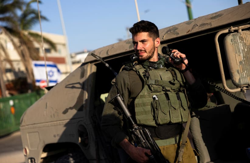  An Israeli soldier stands by a military vehicle, amid the ongoing conflict between Israel and the Palestinian Islamist group Hamas, near Israel's border with Gaza in southern Israel, November 4, 2023 (photo credit: AMIR COHEN/REUTERS)
