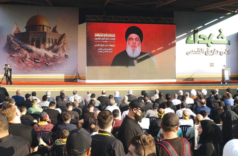  HEZBOLLAH LEADER Sheikh Hassan Nasrallah delivers a video address at a ceremony in Beirut’s southern suburbs, last Friday. (photo credit: ALAA AL-MARJANI/REUTERS)