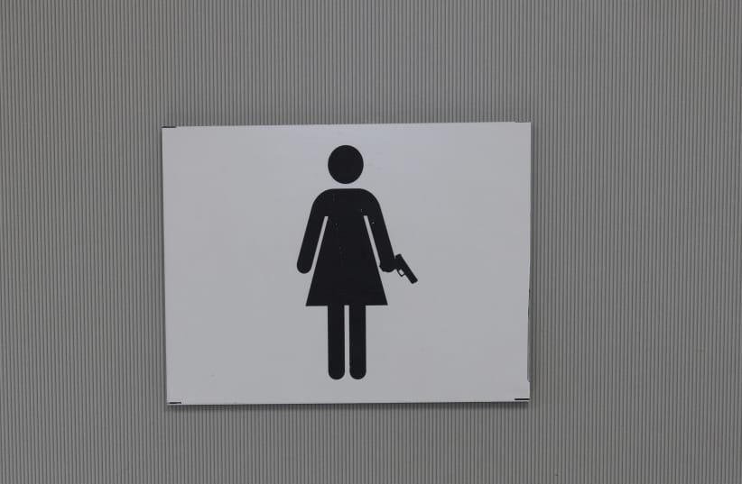  The sign for the women's bathroom at Caliber 3. (photo credit: MARC ISRAEL SELLEM/THE JERUSALEM POST)