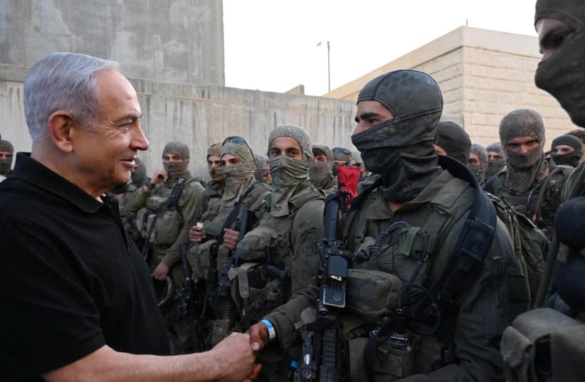  Israeli Prime Minister Benjamin Netanyahu greets a soldier as he visits an Israeli army base in Tze'elim, Israel November 7, 2023. (photo credit: Israeli Government Press Office/Haim Zach/Handout via REUTERS)