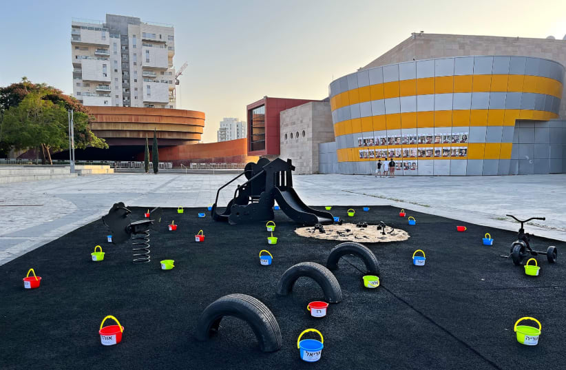  The new playground in front of Holon's Mediatheque dedicated to the child hostages in Gaza. Posters of the captive children are plastered against the building. (photo credit: HOLON MUNICIPALITY)