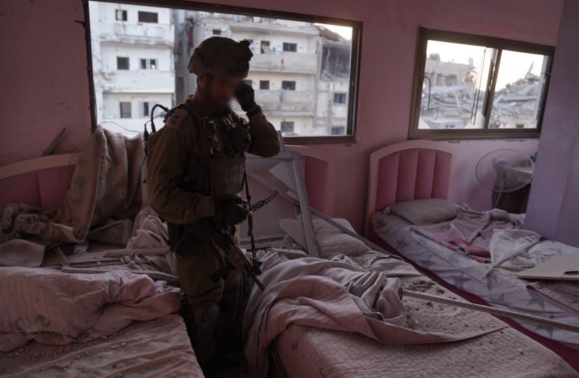  An IDF soldier in a bedroom located next to a Hamas weapons factory in northern Gaza. (photo credit: IDF SPOKESPERSON'S UNIT)