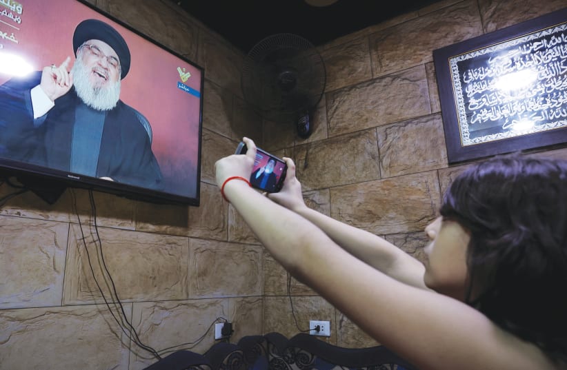  WATCHING HEZBOLLAH Secretary-General Hassan Nasrallah’s speech, in Bourj al-Barajneh, a Palestinian refugee camp in Beirut, Nov. 3. (photo credit: Amr Alfiky/Reuters)
