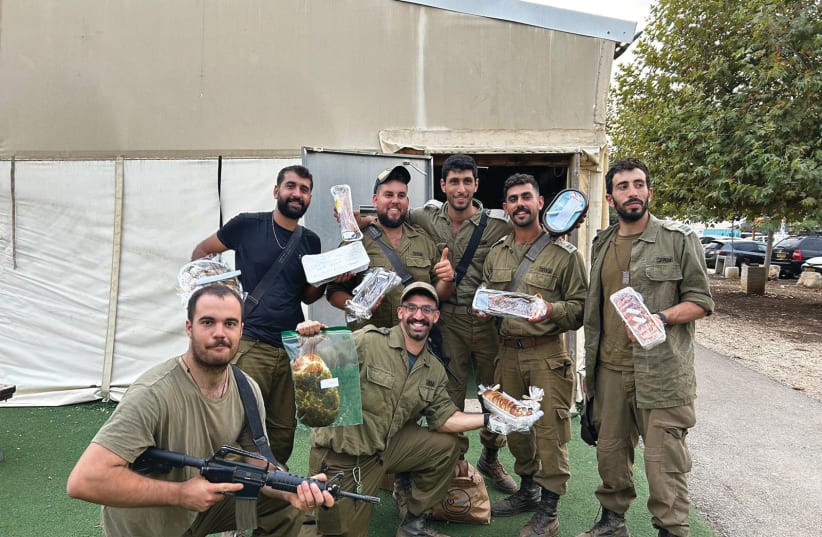  IDF SOLDIERS enjoy a delivery of baked goods. (photo credit: Hamal for Sweets)